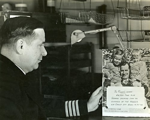 Captain Rowe Views Photo of Von Bulow, USS Ranger